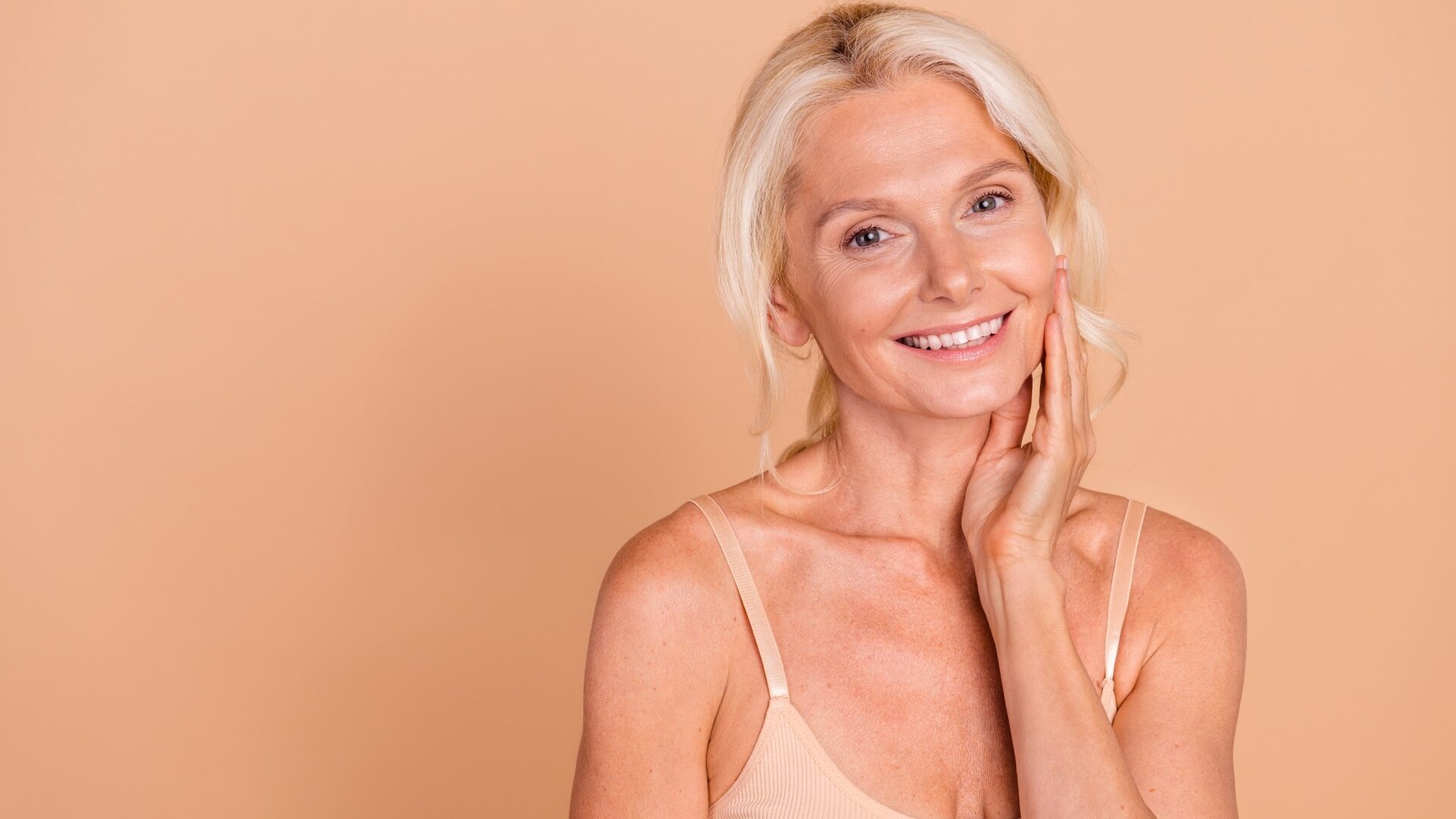 Photo of adorable positive lady hand touch pure fresh silky perfect skin facelift procedure empty space isolated on beige color background